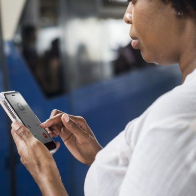 futuristic social media technology concept with diverse people using smartphones and digital devices