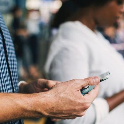 person using smartphone to trade cryptocurrency with security icons