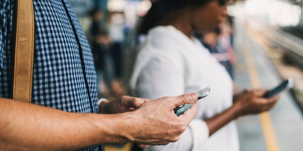 person using smartphone to trade cryptocurrency with security icons